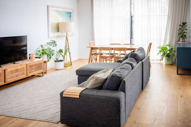 istock Spacious living room with grey couch and large TV. 2191576093
