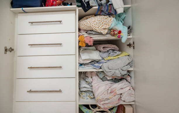 istock Wardrobe clutter with clothes and linens disorderly 2191576488