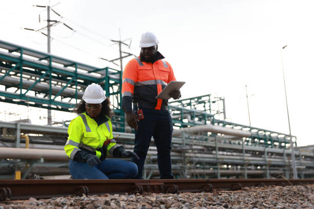 istock The Systems engineering team members performed preventive maintenance on the factory's piping and inspected the survey for the railway work station, set against the oil refinery factory in the background 2191577114