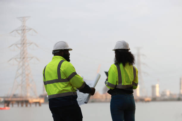 istock A man and a woman, both engineers, wear green safety jackets while working at a renewable energy facility focused on producing clean, environmentally friendly power with no carbon emissions. 2191577674