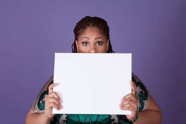 Beautiful plus size black woman holding a sign with room for copy