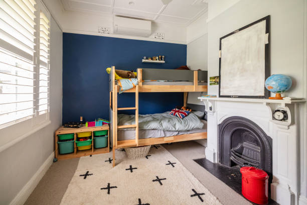 Colorful kids room featuring a bright blue accent wall and practical bunk beds, providing a lively yet functional atmosphere perfect for play and relaxation.