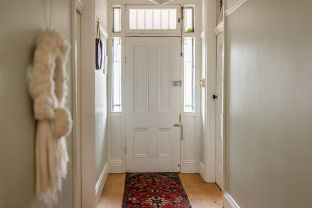 istock Narrow hallway with white door and decorative carpet 2191580086