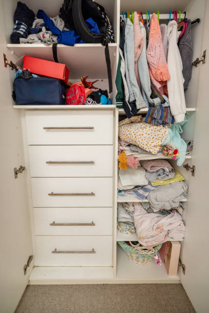 istock Organized closet space with hanging clothes and drawers. 2191580139