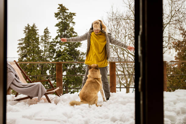 istock Woman playing with a dog on cold fresh air 2191580903