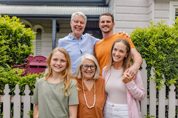 istock Family enjoying a moment by their charming residence 2191581649