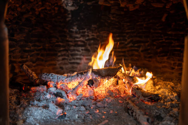 istock Glowing Embers and Flames in Rustic Brick Fireplace 2191581722