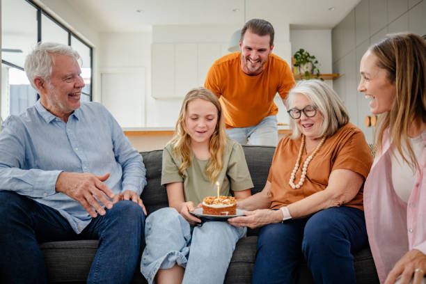 istock Family gathered around a birthday cake sharing joy. 2191581861