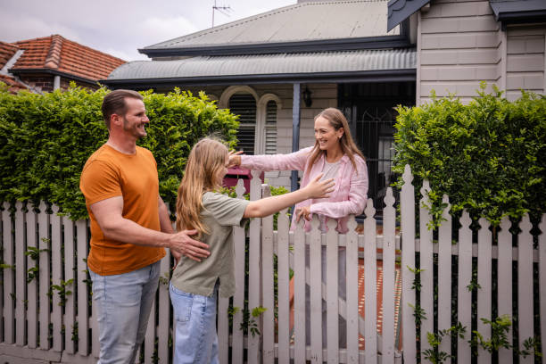 istock Family greeting at the picket fence joyfully 2191582372
