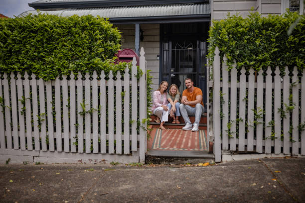 istock Family posing affectionately on house's front steps 2191582511
