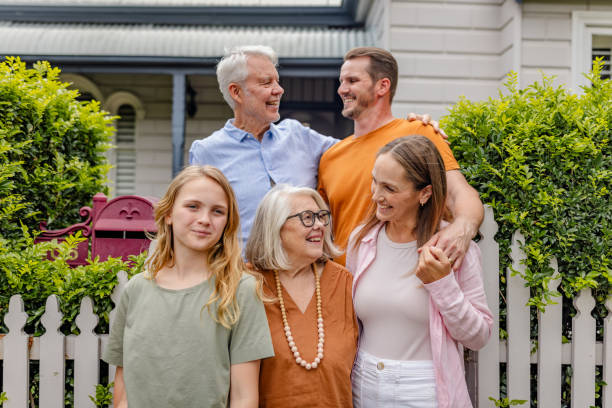 istock Generations unite happily by a picket fence residence 2191583041