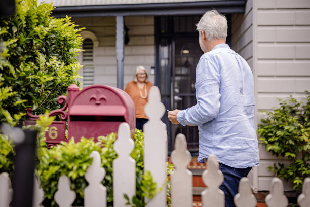 istock Elderly man approaching woman at charming home entrance. 2191586246