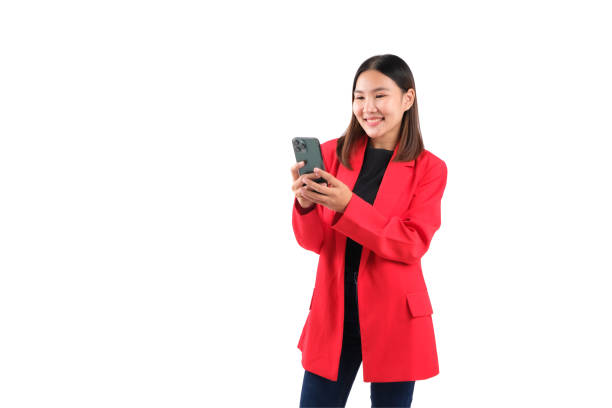 istock Young woman in red blazer smiling while using smartphone on white isolated background. 2191588704