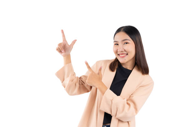 istock Young woman pointing with both hands and smiling, isolated on a white background. 2191588705