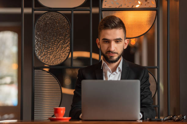 istock A young business man working on a laptop in the office. 2191591524