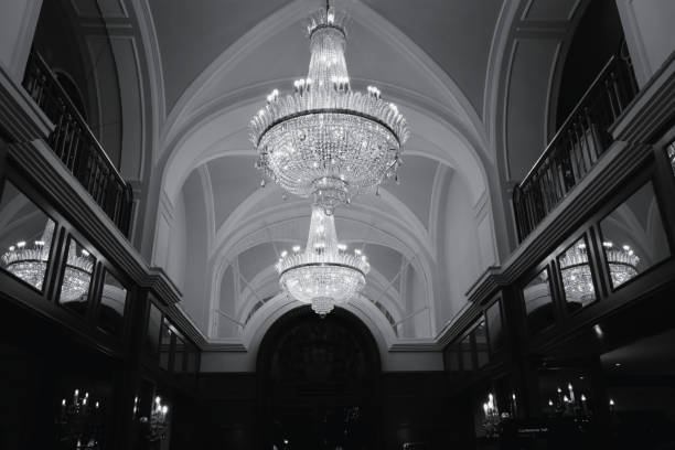 Old vintage chandelier shot close up. Black and white photo of a chandelier hanging from the ceiling.