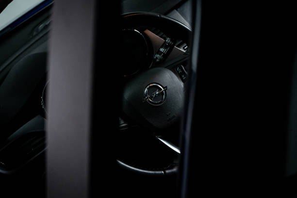 Beja, Portugal. November 20, 2024. Close-up of the Opel logo on a car steering wheel, showcasing the brand's iconic design and craftsmanship.