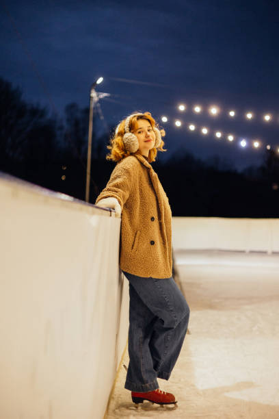 istock Cute woman take break on the ice rink 2191594012