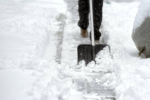istock A man shoveling snow with a plastic shovel. 2191594601
