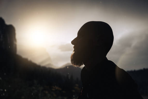 Landscapes of the Italian Dolomites in summer: man portrait with dramatic bad weather scene, with a storm at sunset along Passo Gardena