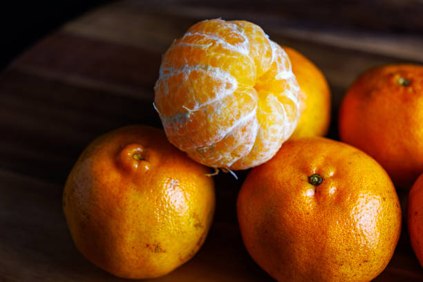 Detailed macro of a ripe mandarin with vivid orange peel and juicy texture, perfect for food, health, and lifestyle concepts