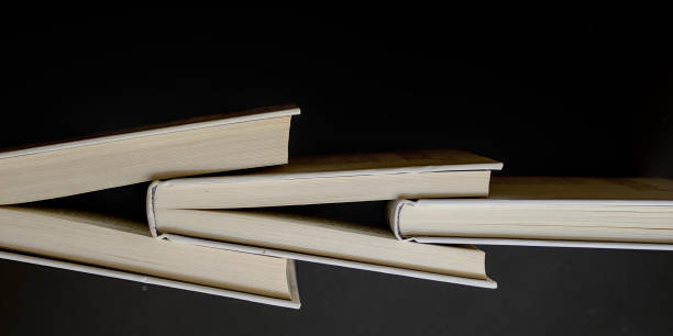 istock cross of books 2191595106