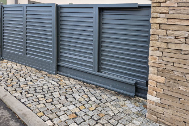 istock sliding door folding into itself. the small space requires the gate to be assembled on a small piece of the yard at the entrance from the street. aluminum slats 2191598241