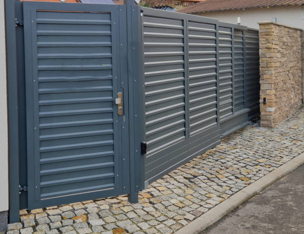 istock sliding door folding into itself. the small space requires the gate to be assembled on a small piece of the yard at the entrance from the street. aluminum slats 2191598297