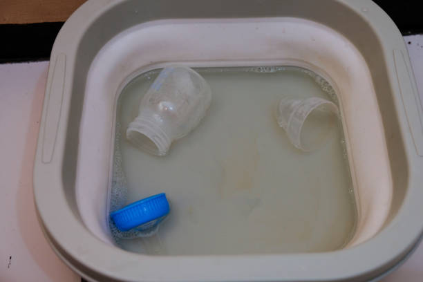 istock Cleaning baby bottles in box sterilizer with hot water 2191600364