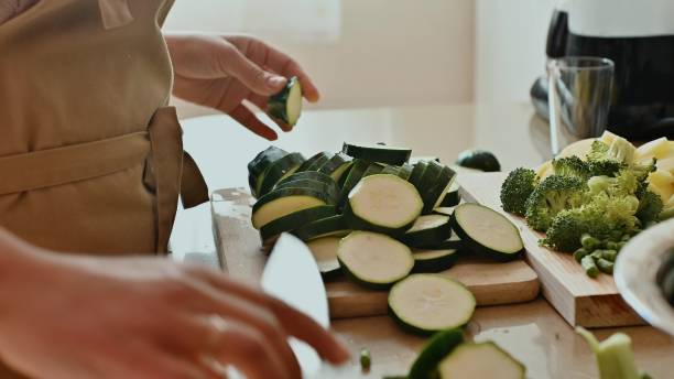 istock Woman chopping vegetables on a cutting board in a kitchen setting 2191601857
