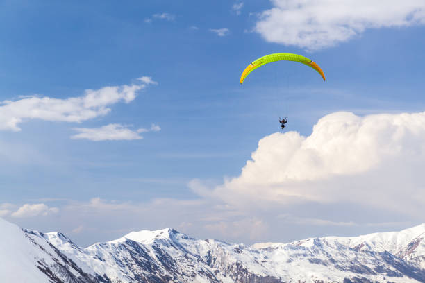 istock Mountain landscape with paragliders flying over snowy peaks 2191602059