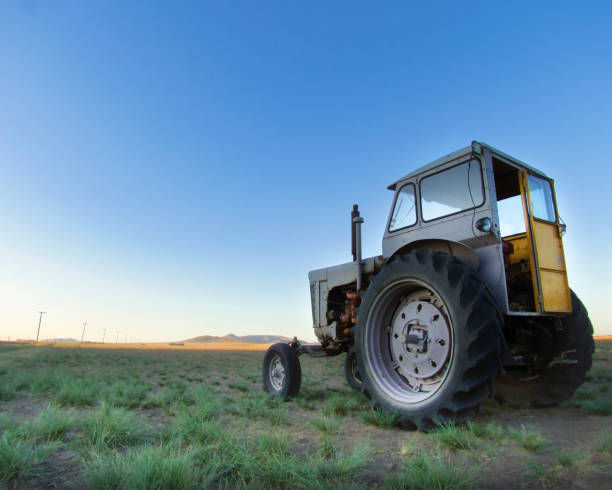 istock Weathered tractor and countryside scenery at twilight 2191605175