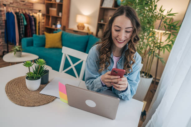 istock A woman using her phone in a modern dining room 2191607837