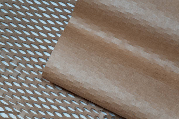 The photograph highlights a vivid contrast between the dense, neat texture of the unstretched wrapping paper and the unfolded, voluminous structure of the stretched wrapping paper.
