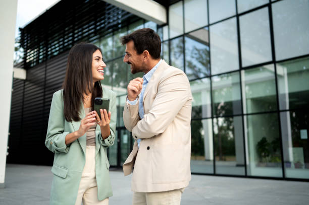 istock Business team outdoor talking and using smart phone 2191608068