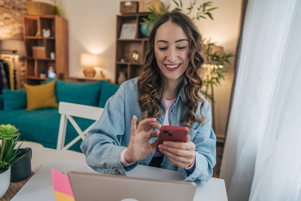istock A woman using her phone in a modern dining room 2191608084