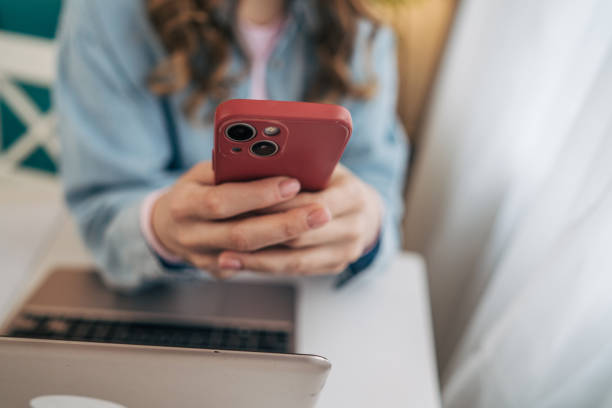 istock A close up picture woman using her phone in a modern dining room 2191608097