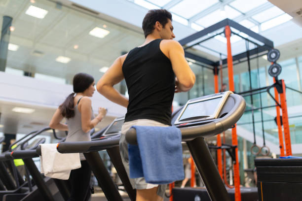 istock Athletes running on treadmills in modern gym 2191608732