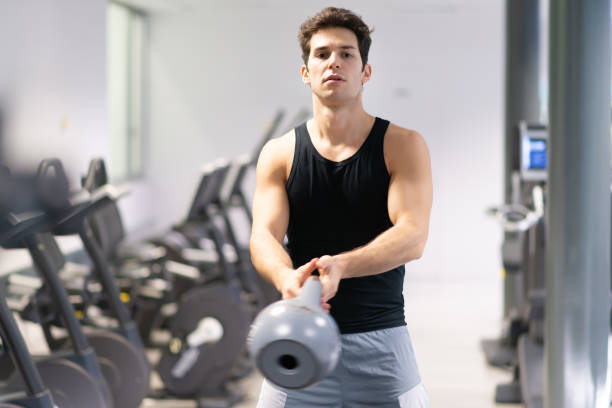 istock Determined athlete exercising with steel mace in modern gym 2191609330