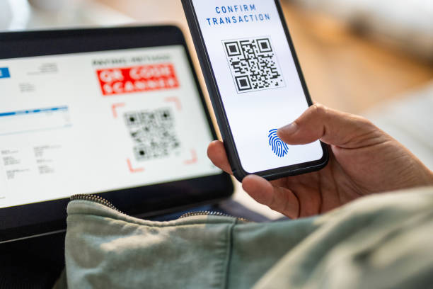 istock Mid Adult Man Completes Online Purchase Using QR Code at Home 2191609943