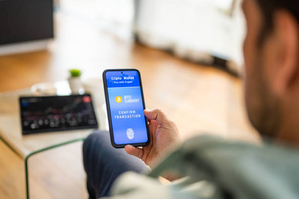 istock Caucasian Male Completes Bitcoin Transaction with Fingerprint Authentication at Home 2191609945