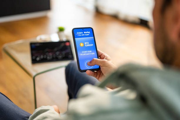 istock Caucasian Man Conducting Bitcoin Transaction with Fingerprint Authentication 2191609951