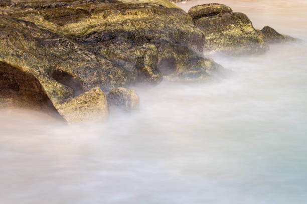 sea shore rock with water mist long exposure shot