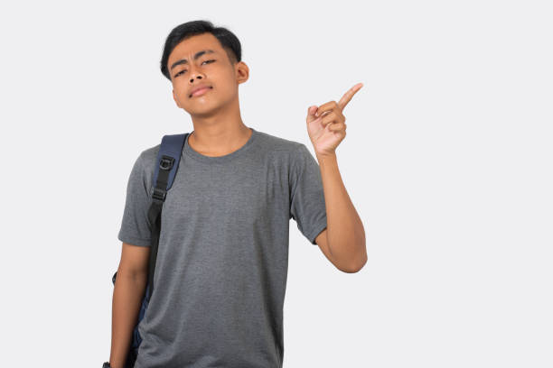 istock Young college student pointing with finger presenting on white background 2191611744