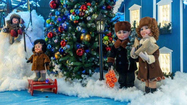 istock This festive scene features realistic parent dolls surrounded by colorful Christmas decorations and toys, with a beautifully adorned Christmas tree in the background, all set in a lively shopping mall. 2191615255