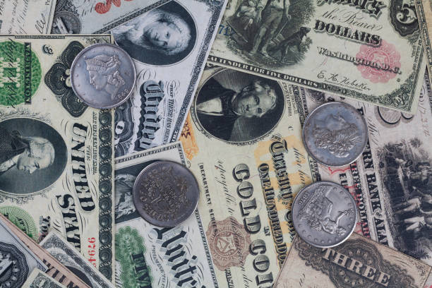 istock Old west US banknotes and silver certificates with silver dollar coins 2191617570