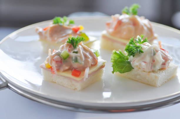 canape or toast with ham , cheese , crab stick and tuna for serve