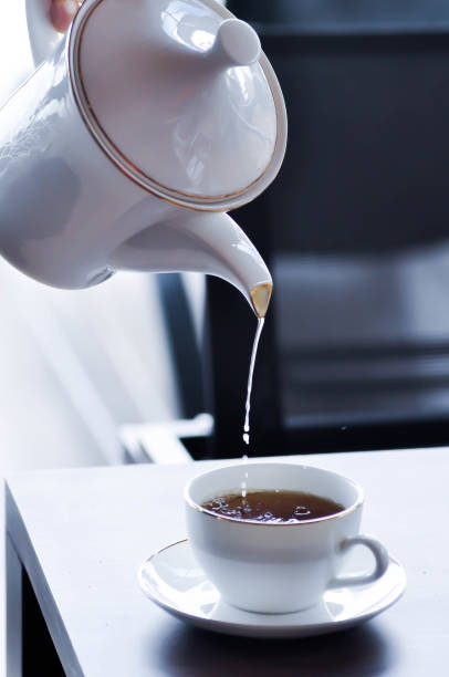istock pouring tea , tea cup and tea pot or hot tea 2191619202