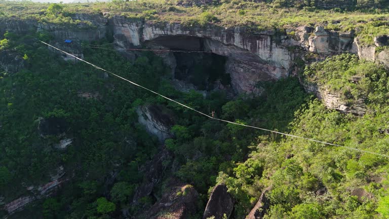 Aerial descend zoom-in highliner on highline Gruta do Lapão, Chapada Diamantina, Bahia