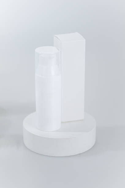 istock Simple, minimalist mock up of a white cosmetic bottle and a rectangular box 2191627140